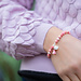 Biba Roze kralenarmband met kwast en schelp