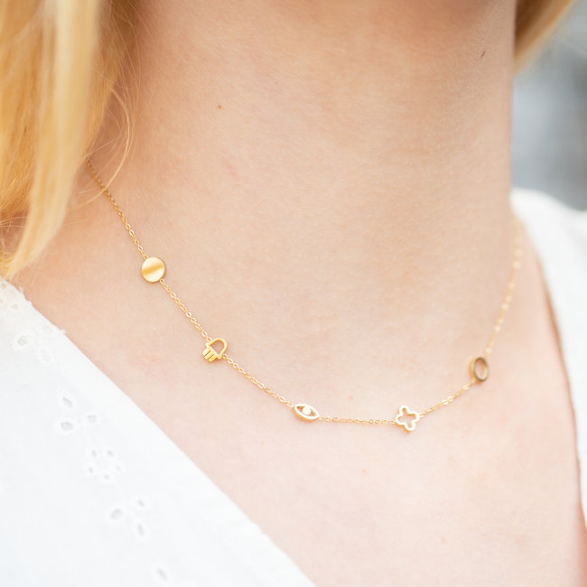 Goudkleurige ketting met symbolen klaver, hamsa, oogje