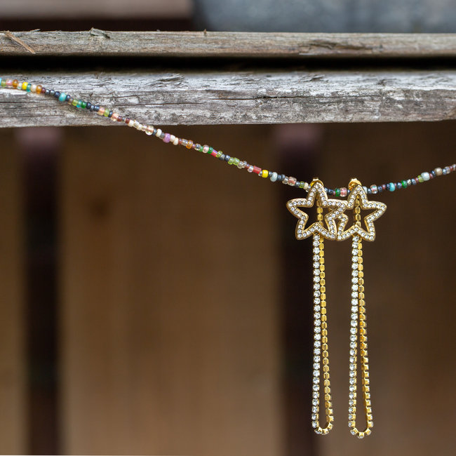 Day & Eve  Gouden oorhangers met sterren en kristal