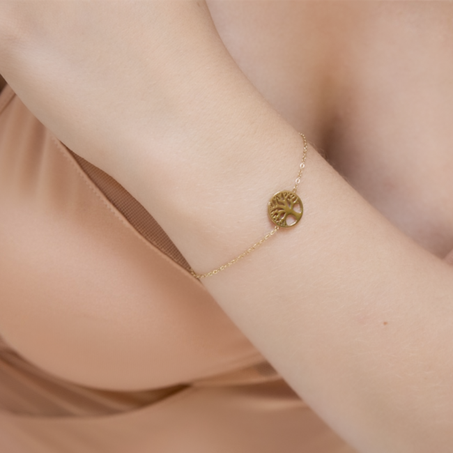 Goud armbandje levensboom of witte pareltjes