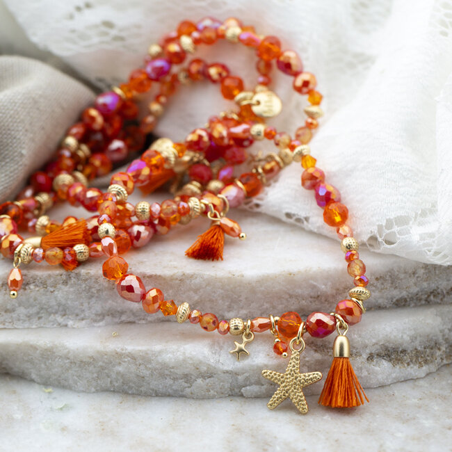 Oranje facetkralen armband met zeester en kwastje