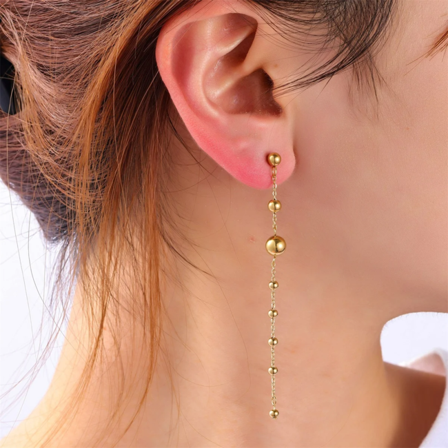 Day & Eve  Lange goud bolletjes stainless steel oorbellen