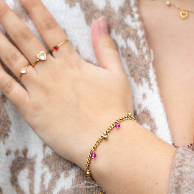 Goud stainless steel schakel armband met roze kralen bedels