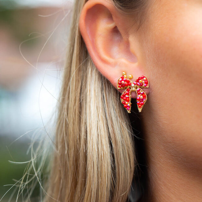 Biba Goud oorbellen met  rode sparkle kralen strik