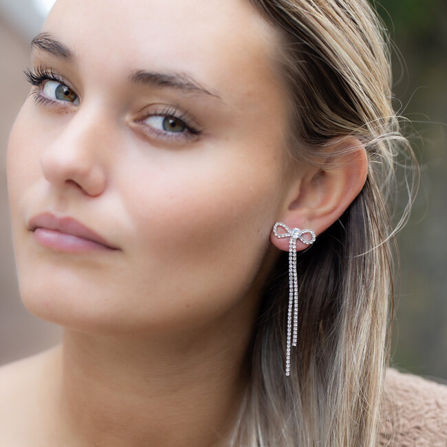 Zilver party strik oorbellen met glitter steentjes