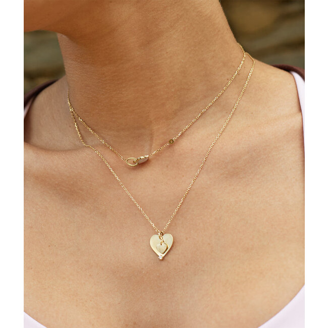 Goud ketting met hart of parelmoer klaver