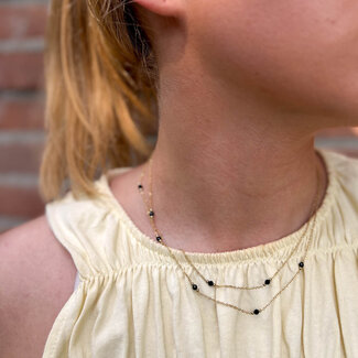 ZAG  Bijoux Dubbele goudkleurige ketting met zwarte facetkraaltjes