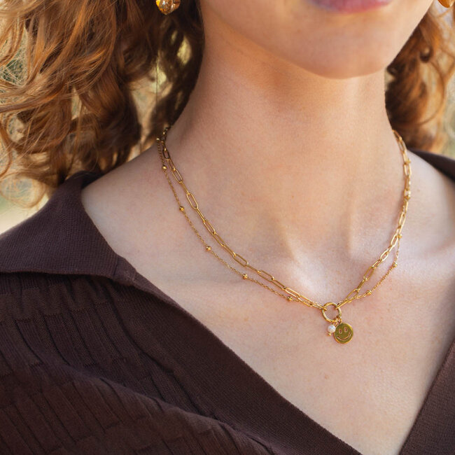 Day & Eve  Goud stainless steel ketting met smiley en parel