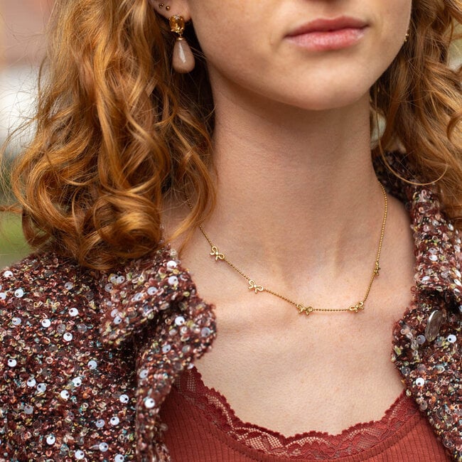Day&Eve Goud kleurige ketting met strikjes