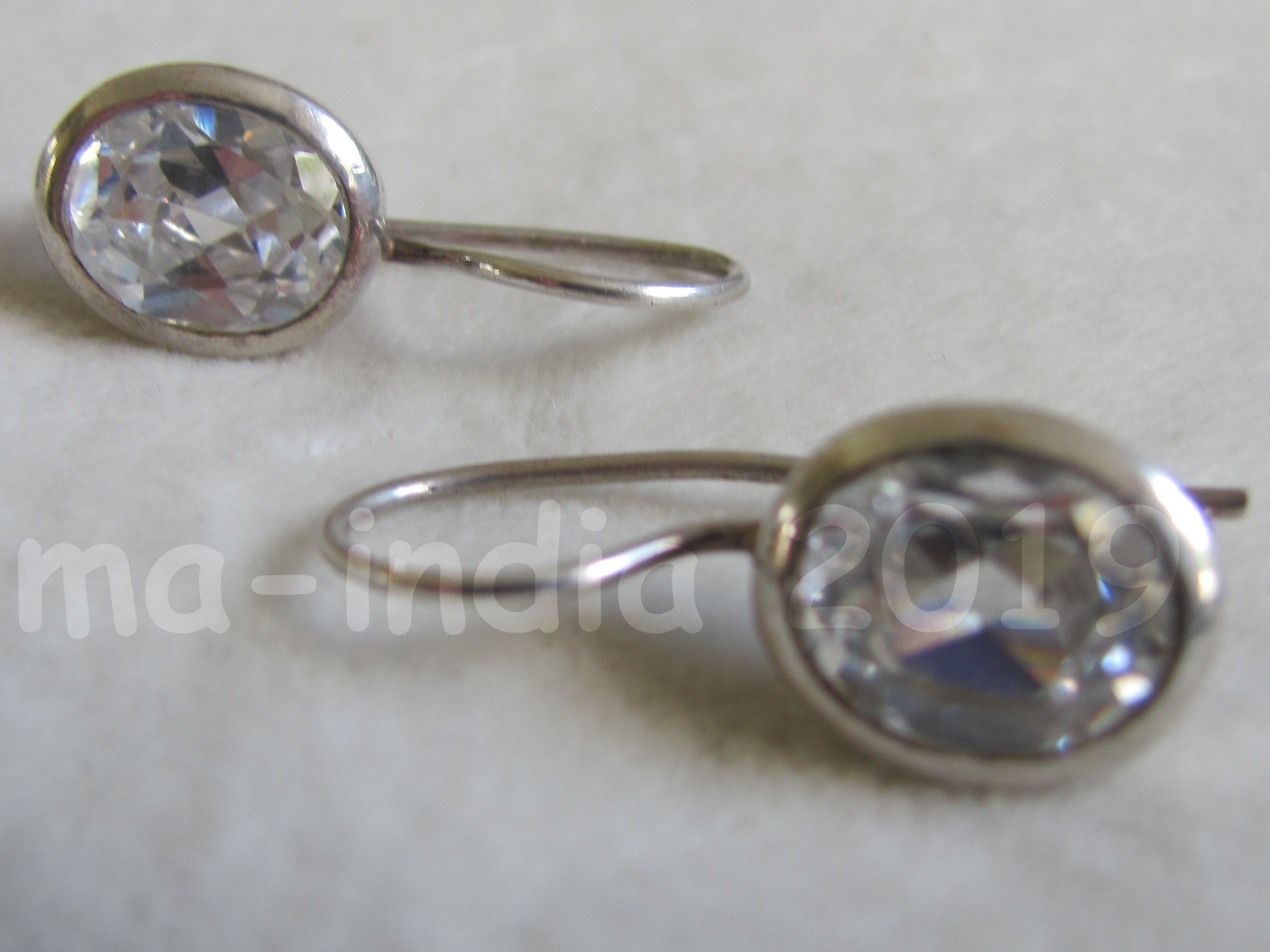 Silver earring,  dormeuse  model  with oval zircon