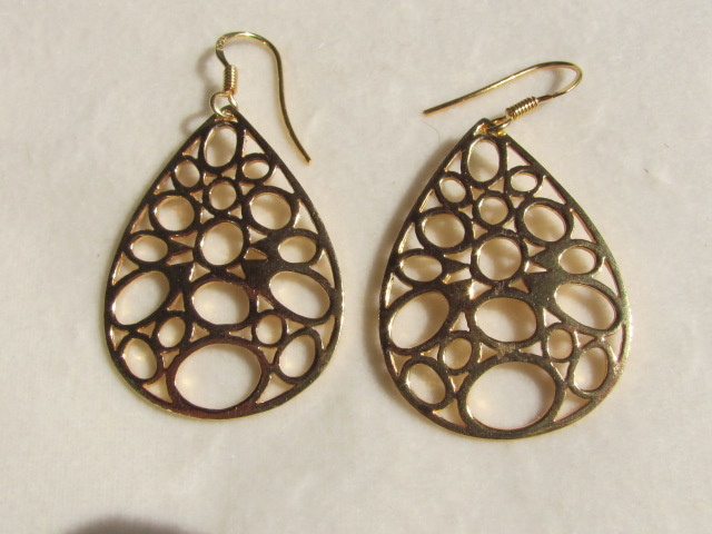 Earrings. Gold on silver, cut work