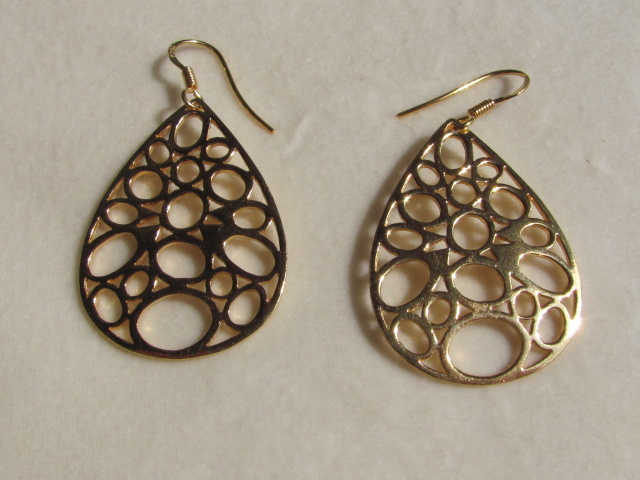 Earrings. Gold on silver, cut work