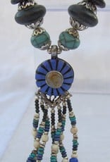 Necklace with beaded tassel and blue medallion