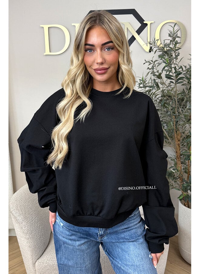 BLACK - ‘SOLÈNE SWEATER’ – OVERSIZED LAYERED RUFFLE SLEEVE SWEATER