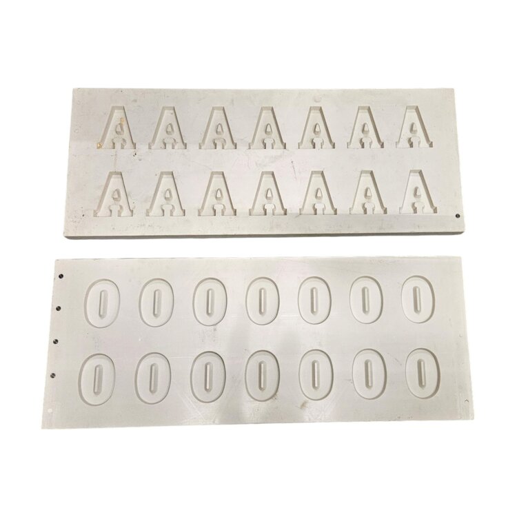 Two Verkade chocolate letter molds