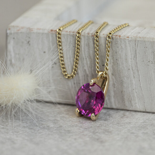 14 karat gold pendant with pink gemstone