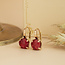 Gold ear jewelry with red gemstone 18 karat