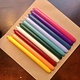 A package with 10 candles in 10  different colours