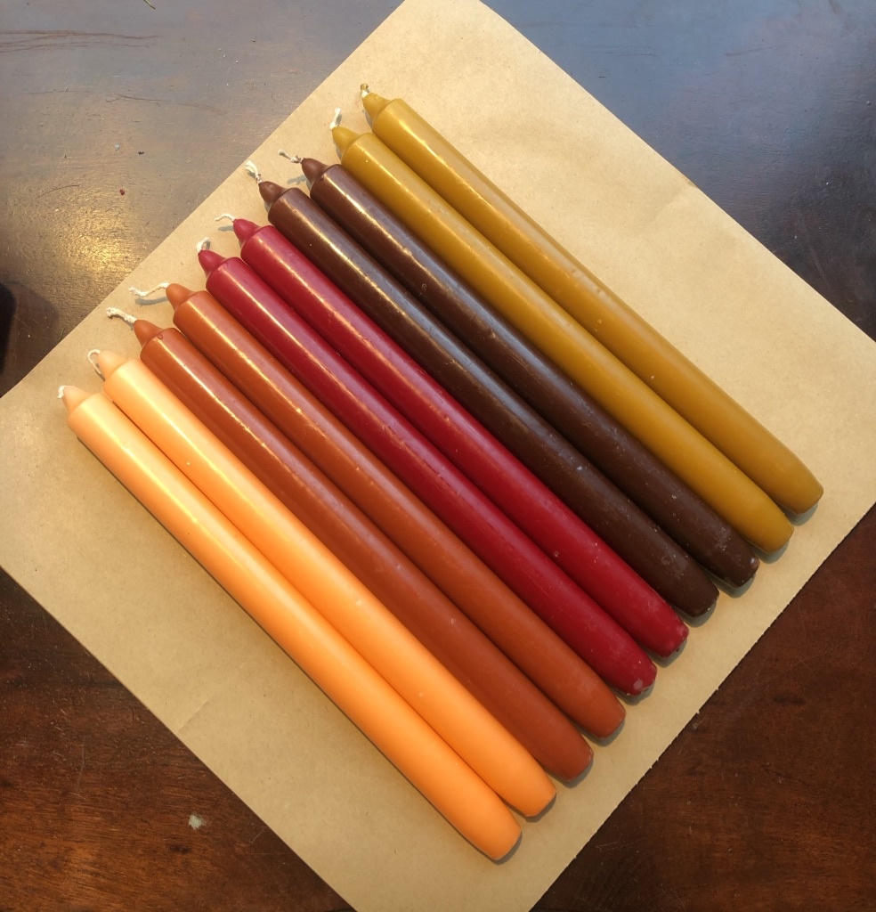 A package with 10 candles in colours that make you think of sundown.