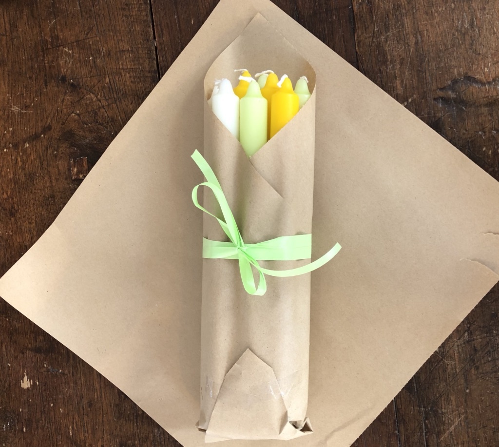 A package with 10 candles in colours to bring  Spring or Easter to your home