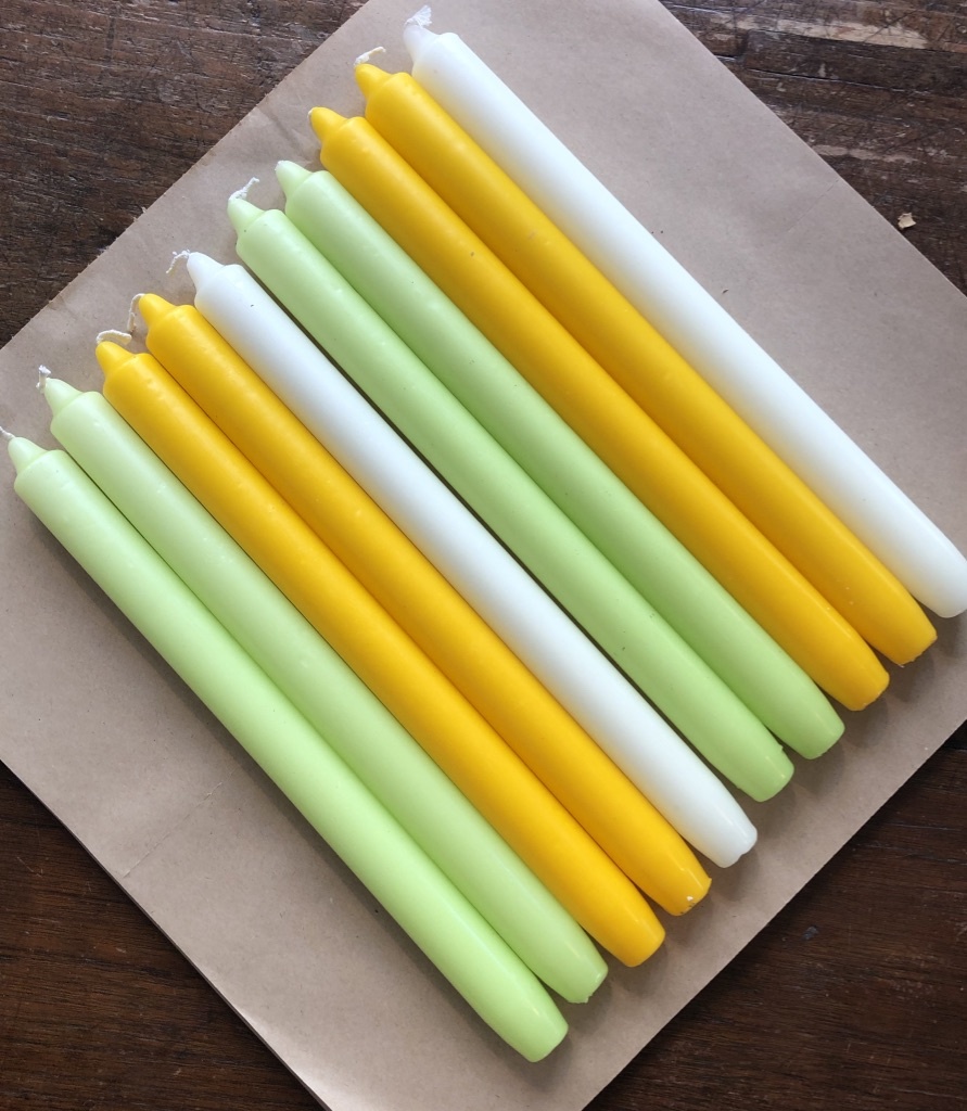 A package with 10 candles in colours to bring  Spring or Easter to your home