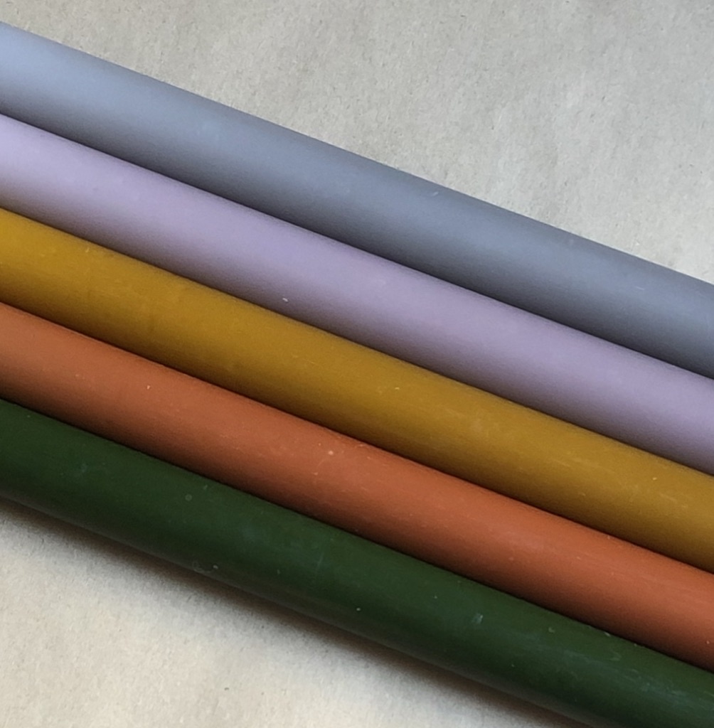 A package with 10 candles in colours that remind you of nature