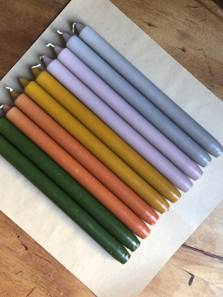 A package with 10 candles in colours that remind you of nature