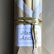 A package with 10 candles in colours that remind you of beach sand