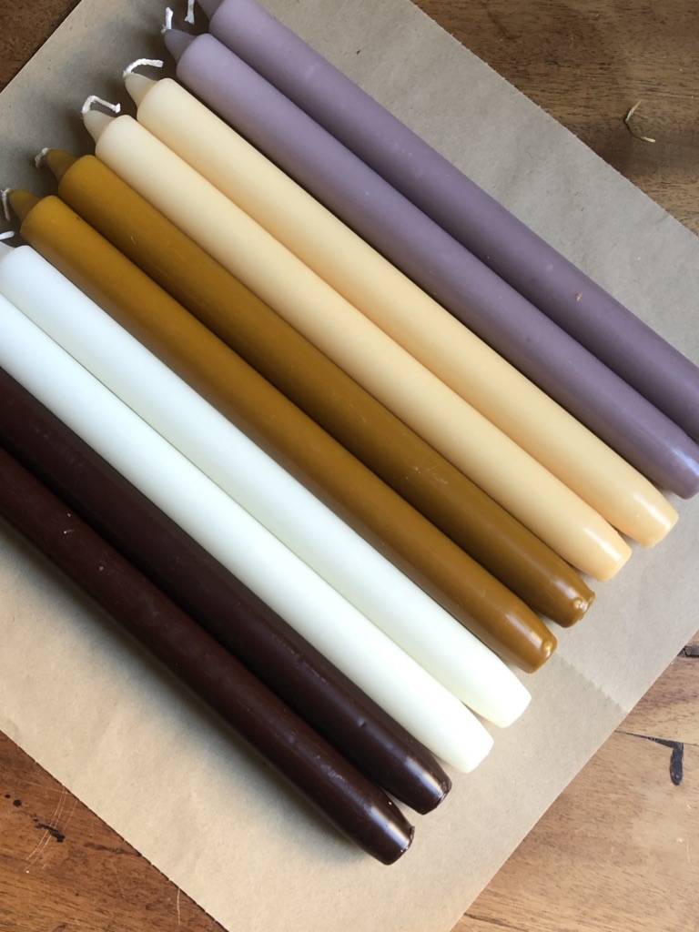 A package with 10 candles in colours that remind you of beach sand