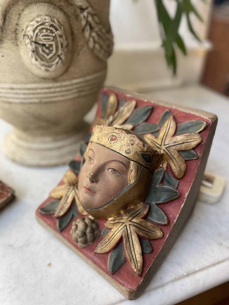 Antique console with a sweet face of a lady