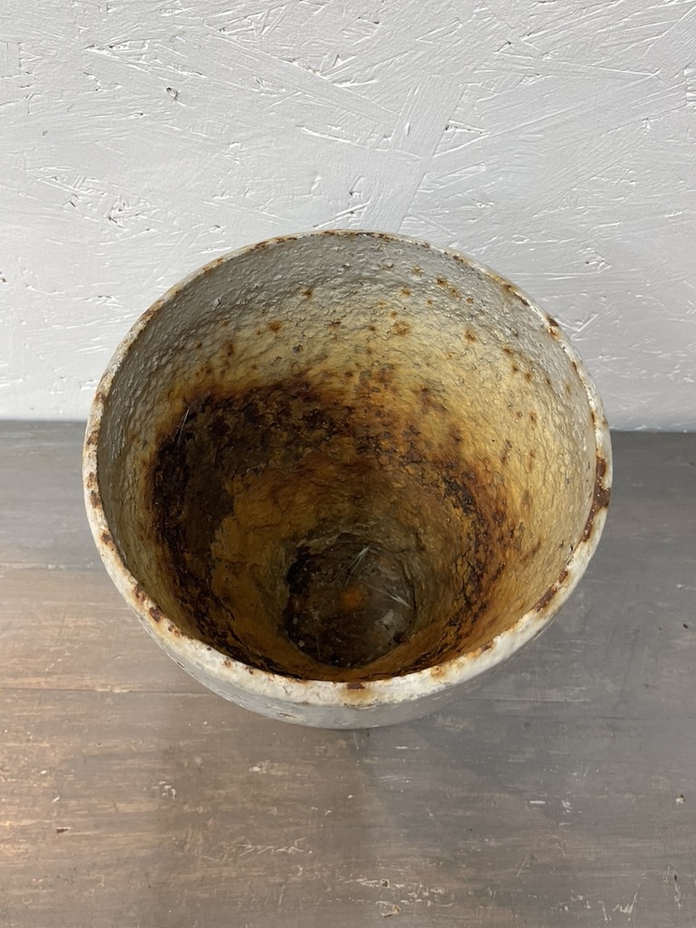 Antique cast iron vase, leaning a bit