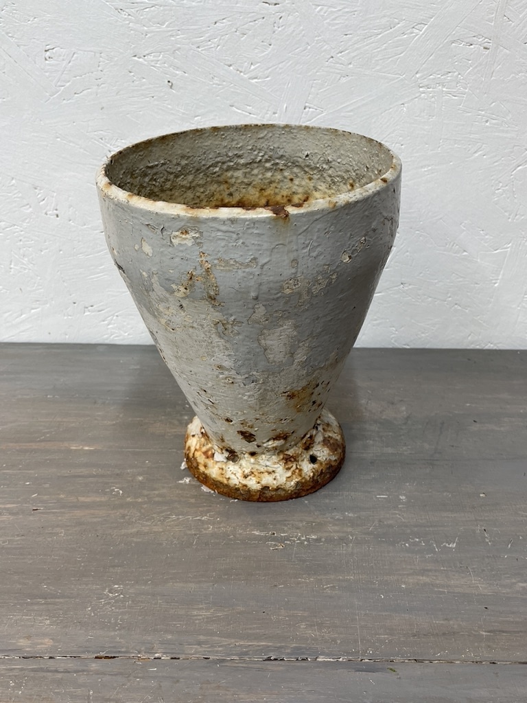 Antique cast iron vase, leaning a bit
