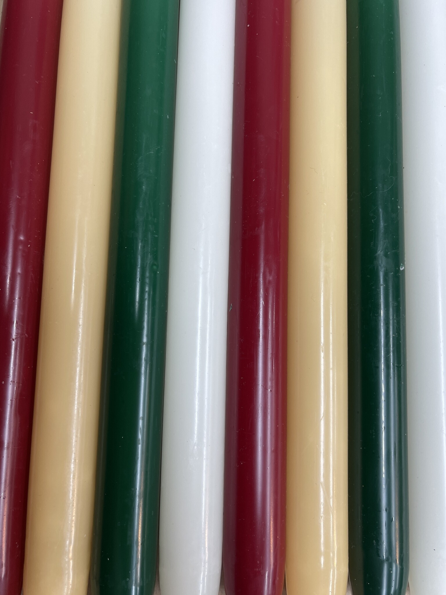 A package with 10 candles, red,  green , ivory and old ivory for Christmas