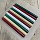 A package with 10 candles, red,  green , ivory and old ivory for Christmas