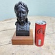 Old statue of a dame mounted on a wooden console