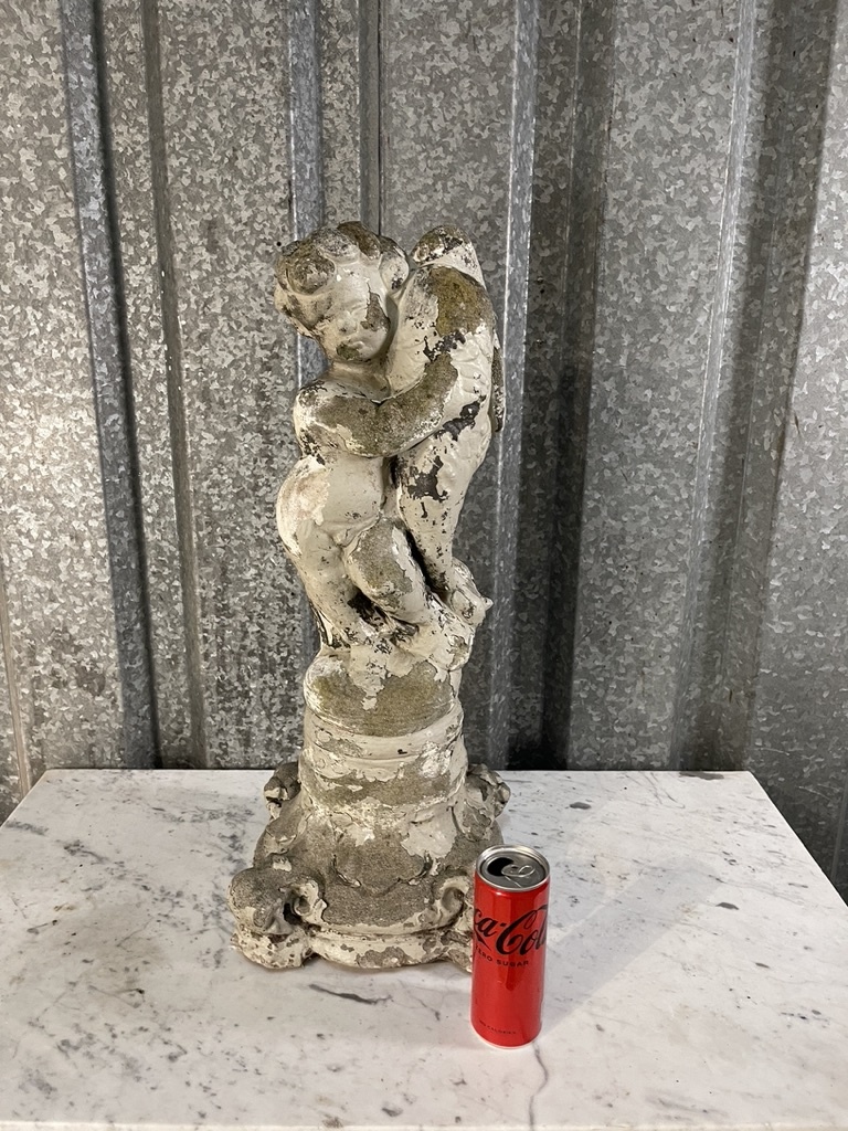 Antique garden statue, little guy with large fish