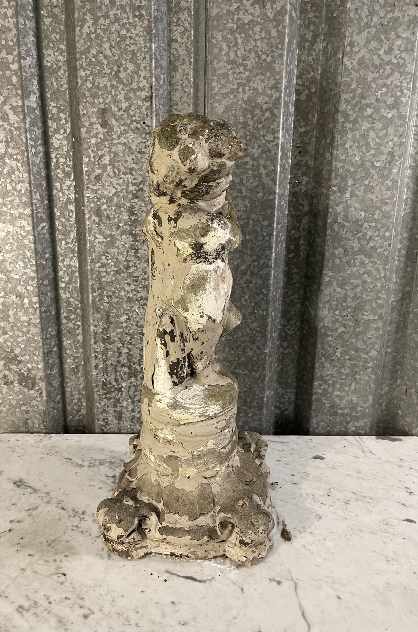 Antique garden statue, little guy with large fish