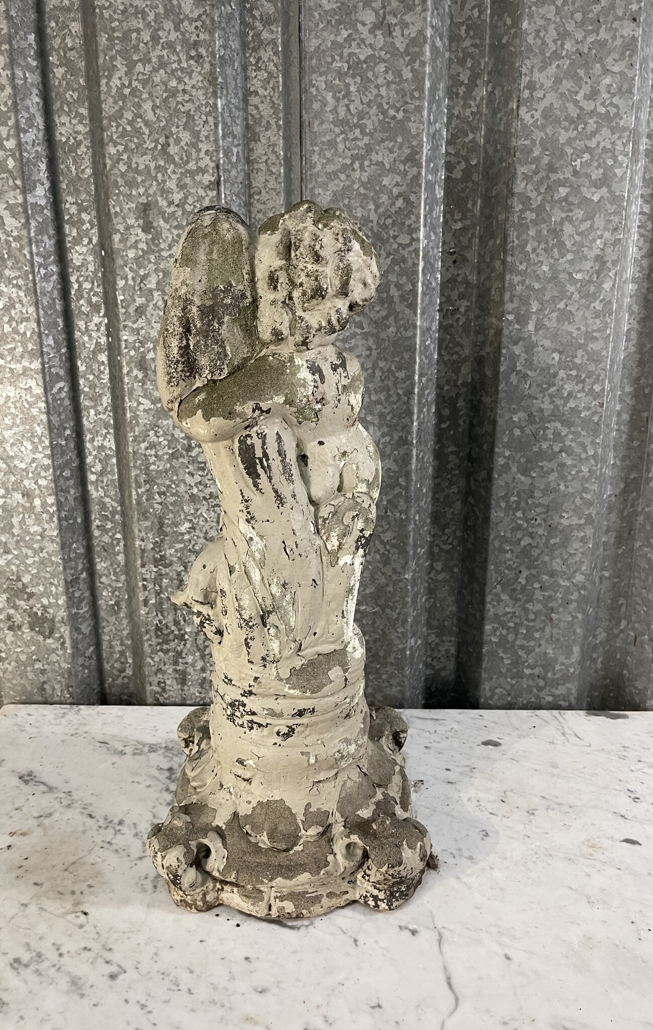 Antique garden statue, little guy with large fish