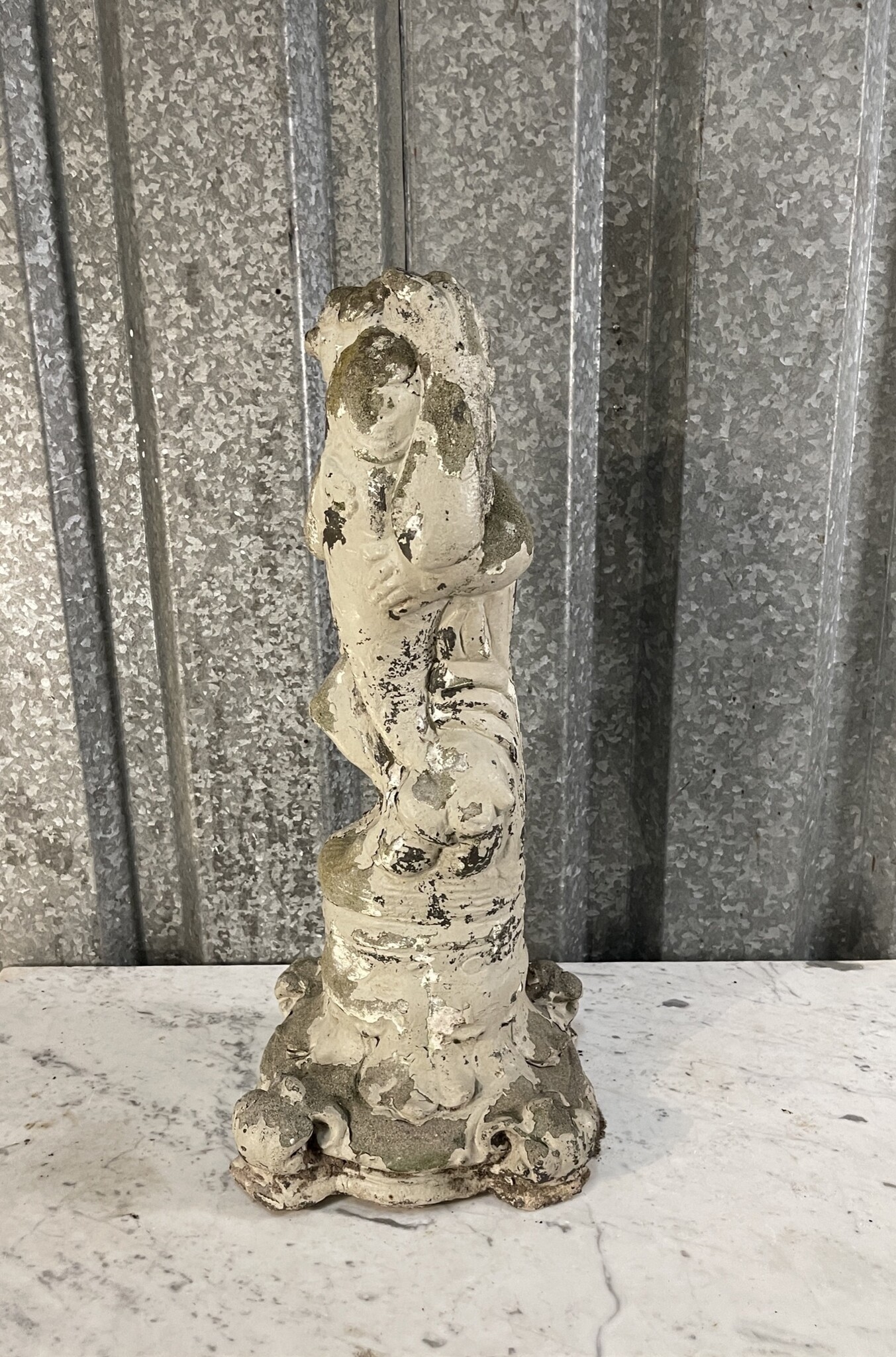 Antique garden statue, little guy with large fish