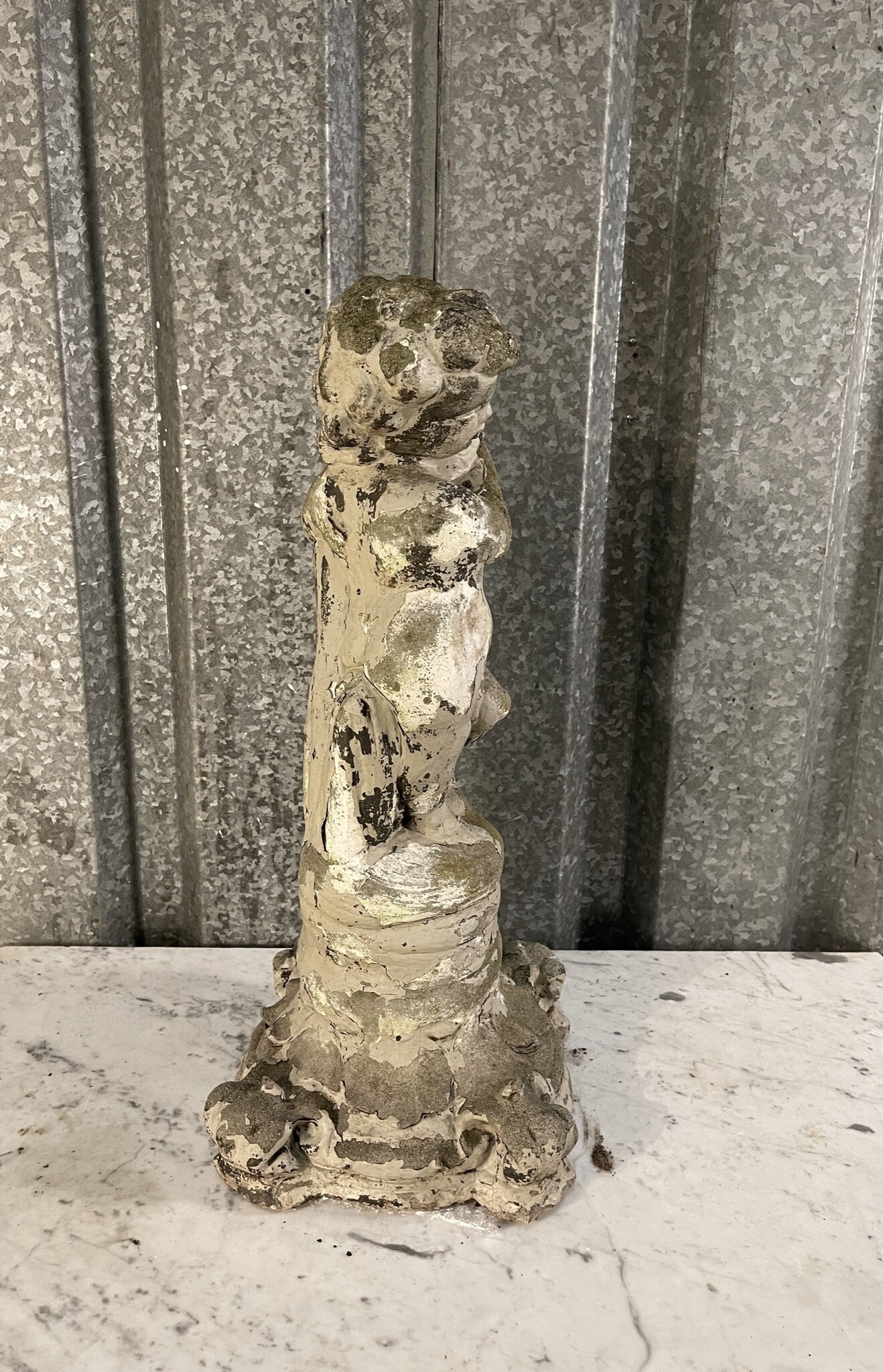 Antique garden statue, little guy with large fish