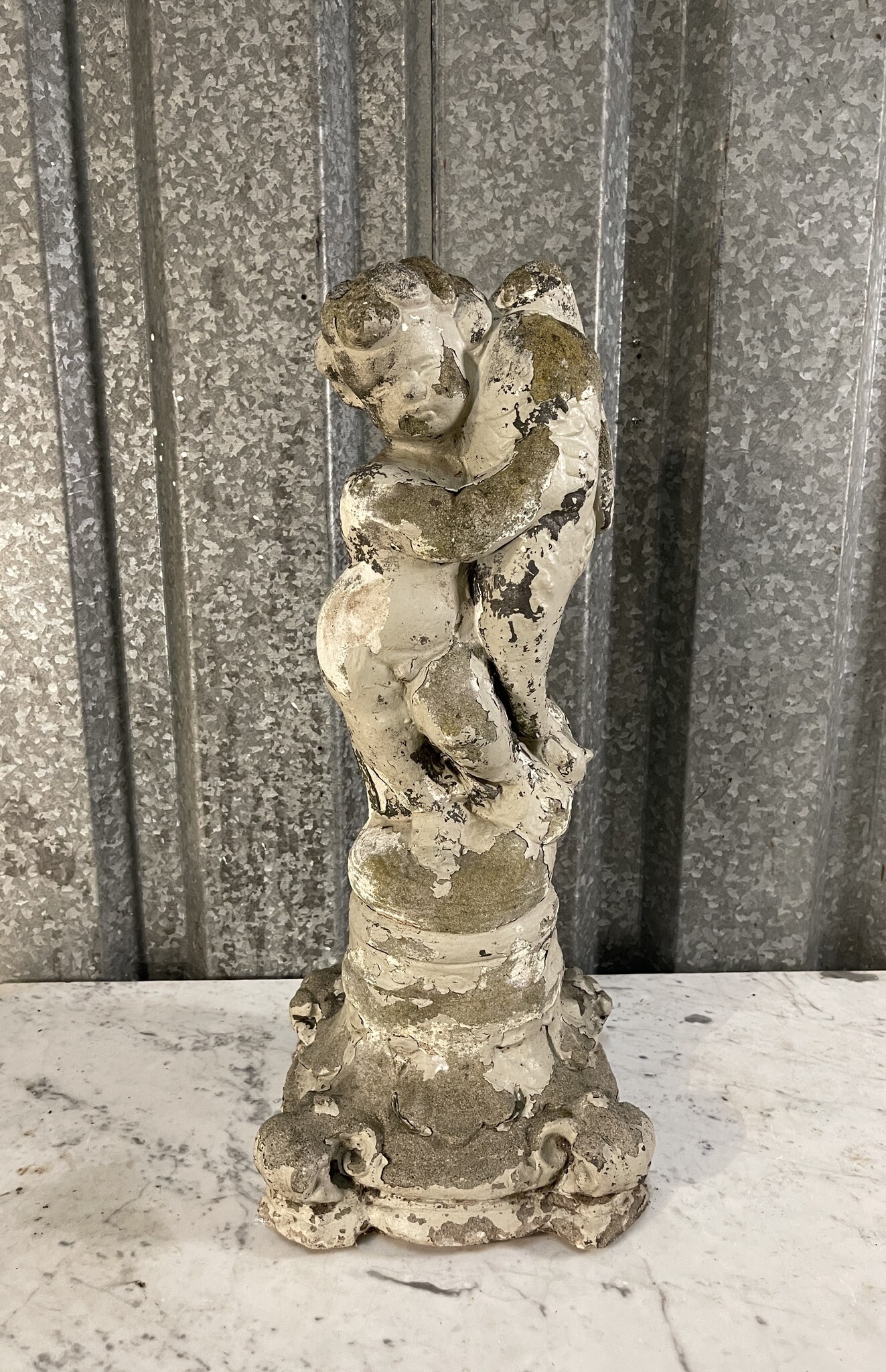 Antique garden statue, little guy with large fish