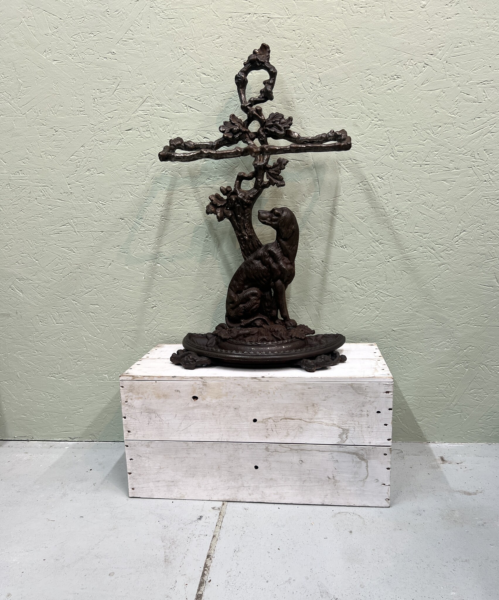 Oude gietijzeren paraplustandaard met lieve hond