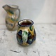 Brightly coloured stone ware pitcher