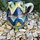 Brightly coloured stone ware pitcher