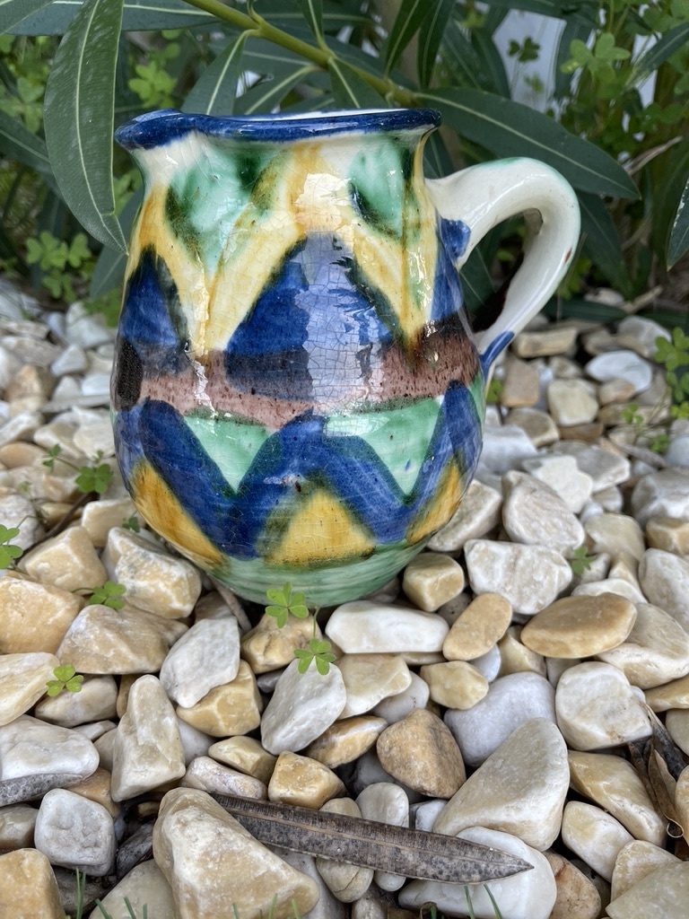 Brightly coloured stone ware pitcher