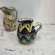 Brightly coloured stone ware pitcher