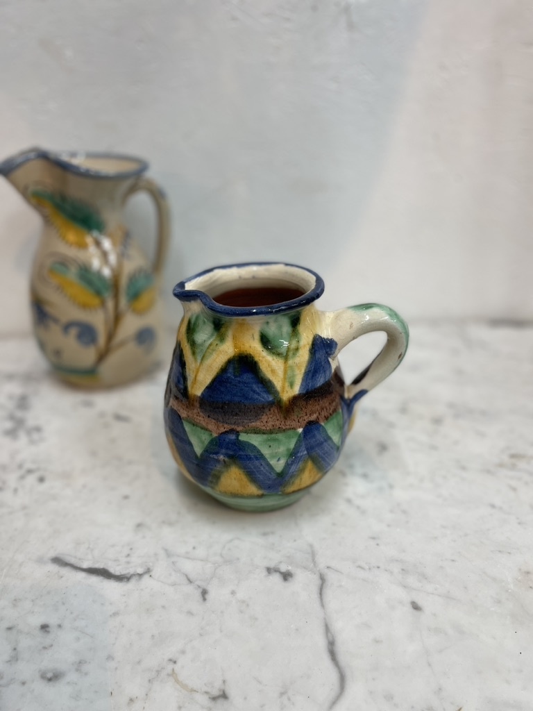 Brightly coloured stone ware pitcher