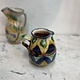 Brightly coloured stone ware pitcher