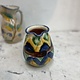 Brightly coloured stone ware pitcher