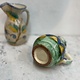 Brightly coloured stone ware pitcher